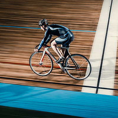 Lone male rider races bike in velodrome